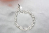 Pulsera con dijes en plata de ley 925: joyas elegantes y atemporales para mujeres
