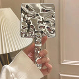 Espejo de maquillaje de mano y de escritorio cuadrado con forma líquida: un elemento esencial de belleza portátil